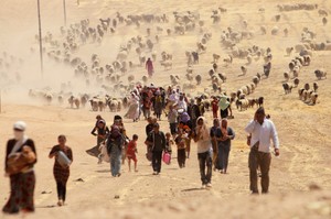 Displaced people from minority Yazidi sect, fleeing violence from forces loyal to Islamic State in Sinjar town, walk towards Syrian border, on outskirts of Sinjar mountain