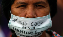 A demonstrator wearing a face mask written with a message takes part in a protest against military rule at Victory Monument in central Bangkok May 26, 2014. Thai coup leader General Prayuth Chan-ocha said on Monday he had been formally endorsed by the king as head of a military council that will run the country, and warned he would use force if political protests flared up again. REUTERS/Athit Perawongmetha (THAILAND - Tags: POLITICS CIVIL UNREST) One of the photos used in Amnesty International's report launch event - photoreel / photo compilation.