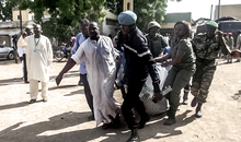 Security forces transport with a blanket the remains of some of the eleven victims of a double blast in the northern Cameroonian city of Maroua on July 22, 2015. Eleven people were killed when two girls blew themselves in twin attacks in a region repeatedly targeted by Nigeria-based Boko Haram jihadists, officials said.