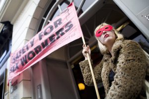 Sex workers and their supporters participate in a demonstration in the Soho district of London on October 9, 2013. The demonstration was staged to protest against the closure of and eviction from premises used by sex workers. AFP PHOTO / JUSTIN TALLIS (Photo credit should read JUSTIN TALLIS/AFP/Getty Images)