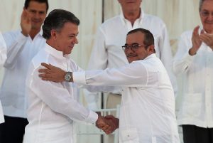 Colombia‚Äôs President Juan Manuel Santos, left, and the top commander of the Revolutionary Armed Forces of Colombia (FARC) Rodrigo Londono, known by the alias Timochenko, shake hands after signing a peace agreement between Colombia‚Äôs government and the FARC to end over 50 years of conflict in Cartagena, Colombia, Monday, Sept. 26, 2016. (